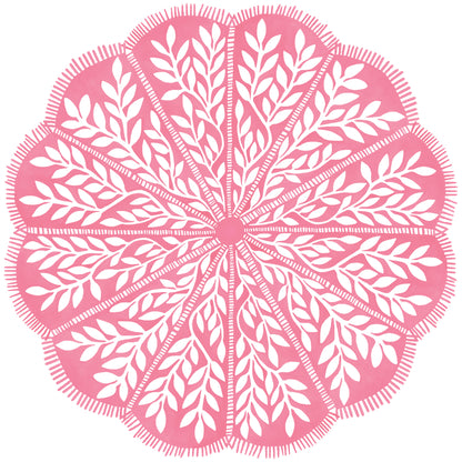 Round scalloped paper placemats featuring a pink and white vine pattern