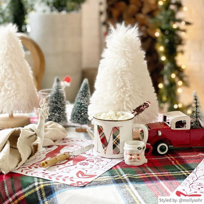 Christmas spread with white and red Reindeer Paper Placemats and red, green and white holiday decor. 